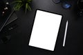 Digital tablet with blank screen, stylus pen, smart watch, glasses and notebook on modern dark workplace. Royalty Free Stock Photo