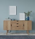 Mock up interior with wooden chest of drawers and two posters