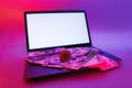 Mock up laptop with white screen and cryptocurrency Bitcoin, dollars and euros against a background of colorful bright neon UV Royalty Free Stock Photo