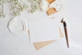 Mock up letter with a love box in the shape of a heart lies on a wooden white table with gypsophila flowers, a greeting card for V Royalty Free Stock Photo