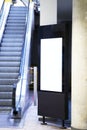 Mock up of light box beside escalator for advertising material Royalty Free Stock Photo