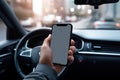 Mock up of a man using blank screen mobile phone inside a car