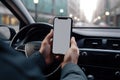 Mock up of a man using blank screen mobile phone inside a car