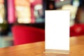 Mock up Menu frame standing on wood table in Bar restaurant cafe. space for text Royalty Free Stock Photo