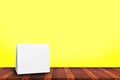 Mock up Menu frame on Table with yellow background,Stand for booklets with white sheets of paper Royalty Free Stock Photo