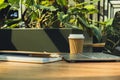 Mock up of modern laptop at table in co-working space. Remote Freelancer's place of work. Study and work online Royalty Free Stock Photo