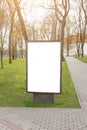 Mock up. Blank billboard outdoors, outdoor advertising, public information board near city park. Royalty Free Stock Photo