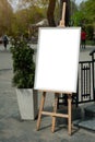 Mock up - painting on an easel in a city.