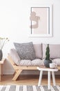 Mock-up painting on a white wall of an artistic living room interior with simple, wooden furniture and patterned decorations