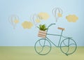 Mock up with paper clouds and flying balloons over the blue pastel background and  toy bicycle Royalty Free Stock Photo
