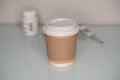 Mock-up of the paper coffee cup with medical supples Royalty Free Stock Photo