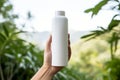 mock-up of a photo of a hand holding an environmentally friendly, biodegradable bottle of cosmetics