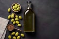 Mock up with plump green olives and bottle of premium olive oil Royalty Free Stock Photo