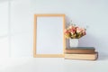 Mock up portrait photo frame with green plant on table, home dec