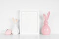 Mock up portrait white frame with Easter Eggs and modern glass bunny decor