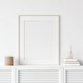 Mock up poster frame on chest of drawers near white wall, Scandinavian style