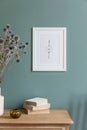 Mock up poster frame and interior accessories on the soft eucalyptus green wall.. Royalty Free Stock Photo