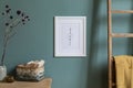 Mock up poster frame and interior accessories on the soft eucalyptus green wall.. Royalty Free Stock Photo