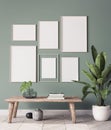 Mock up poster frame in modern interior background, gallery wall in green living room, Scandinavian Boho style Royalty Free Stock Photo