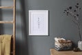 Mock up poster frame and natural interior accessories on the grey wall. Royalty Free Stock Photo