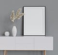 Mock up poster frame on white cabinet in simple home interior. 3d render.