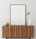 Mock up poster frame on wooden cabinet in home interior