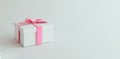 Mock-up poster, gentle white colored gift box with millennial pink bow on white background Royalty Free Stock Photo