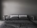 Mock-up poster in modern dark bedroom interior with lamp on table. Bed with gray blanket and pillows. Black empty wall Royalty Free Stock Photo