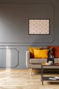 Mock-up poster with pattern on a gray wall and orange cushions o