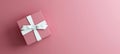 Mock-up poster, rose pink gift box with white bow on pink background Royalty Free Stock Photo