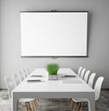 Mock up projection screen in meeting room with conference table, hipster interior background, Royalty Free Stock Photo
