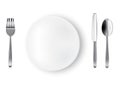 Mock up Realistic White Plate or Dish, Metal Spoon Fork and Knife on Dining Table for food isolated Background. Royalty Free Stock Photo