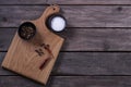 Mock up for restaraunt menu or recipe. Wooden cutting board with salt and pepper on the gray rustic background. Copy