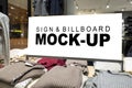 Mock up signboard on shelf show winter cloths in mall Royalty Free Stock Photo