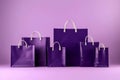 Mock up of six blank dark purple shopping bags isolated on purple background. Fashion product discount. Generative AI
