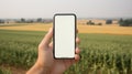 Mock-up smartphone in hand of rice farmer, concept for using tablet application in agricultre for rice or crops growing and rice
