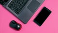 Mock up on the smartphone screen. Flat lay, laptop, smartphone and computer mouse on pink background Royalty Free Stock Photo
