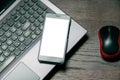 Mock up on the smartphone screen. Flat lay, laptop, smartphone and computer mouse on a wooden table Royalty Free Stock Photo