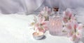 Mock up spa aromatherapy concept with perfume glass or aroma oil glass, flowers and candle on light background.