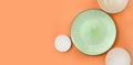 Mock up table setting on orange background. Group of ceramic utensile with plate, bowl and sauser