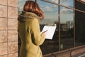 Mock Up of the tablet for the paper in the hands of the girl against the background of the glass center Royalty Free Stock Photo