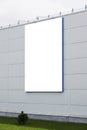 Mock up template. Big vertical white blank signboard, advertising billboard on modern building wall outdoors Royalty Free Stock Photo