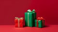Mock up of three red and green gift boxes wiht red and green ribbon isolated on red background, online shopping offer, New year