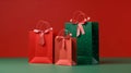 Mock up of three red and green paper shopping bags with ribbon isolated on red and green background, Christmas promotion, gift,