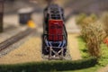 A mock-up of a toy diesel locomotive stands on a siding at a dead end, selective focus