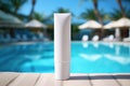 A mock-up of a tube of sunscreen stands near the pool with sun loungers