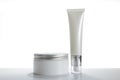 Mock-up two empty container cream pump bottles and a cream jar for skincare is uncover