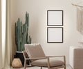 Mock up two square poster frames in boho interior background with beige wall, armchair and cactus, 3D render Royalty Free Stock Photo