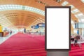 Mock up of vertical blank advertising billboard or light box showcase with people waiting at airport, copy space for Royalty Free Stock Photo