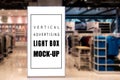 Mock up vertical light box in clothing showroom Royalty Free Stock Photo